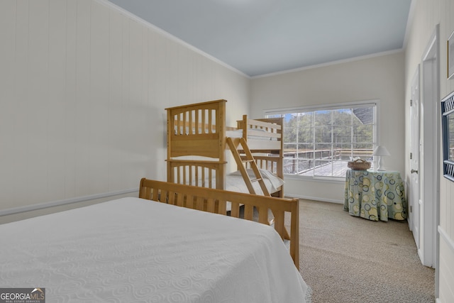 bedroom with ornamental molding and carpet