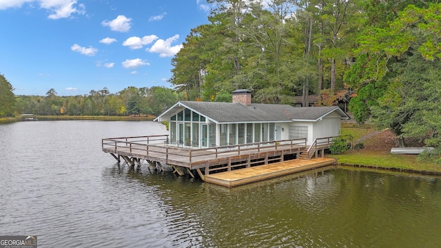 view of dock featuring a water view and a wooded view