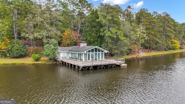 dock area with a water view and a wooded view