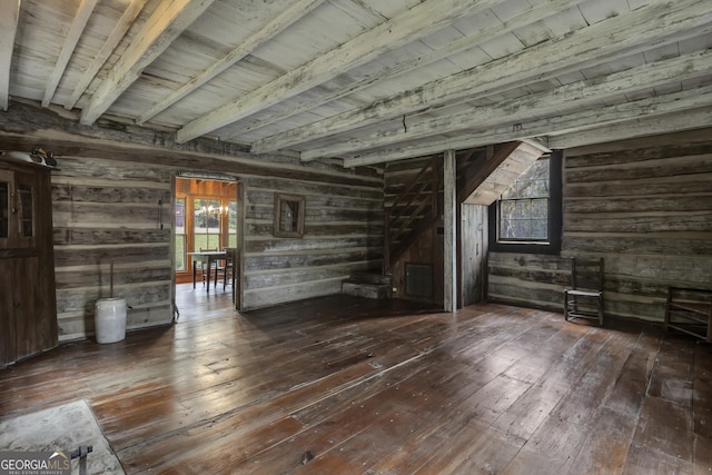 basement featuring dark wood-type flooring and wooden walls