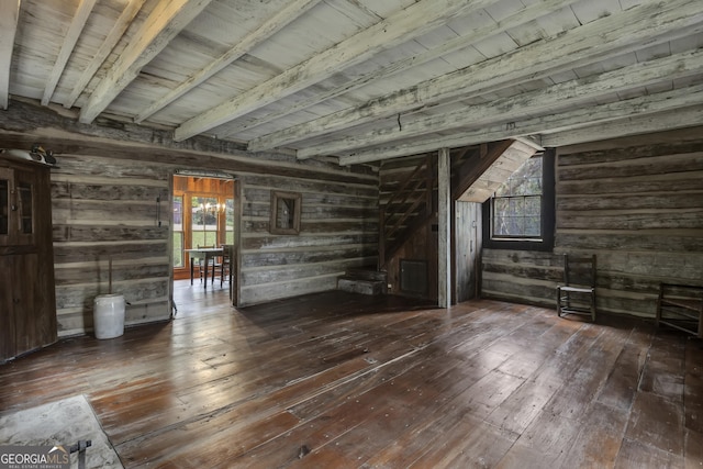 2724 Barnesville Hwy, Thomaston, GA 30286 - unfurnished living room with wood-type flooring, wooden walls, and a wooden ceiling with exposed beams