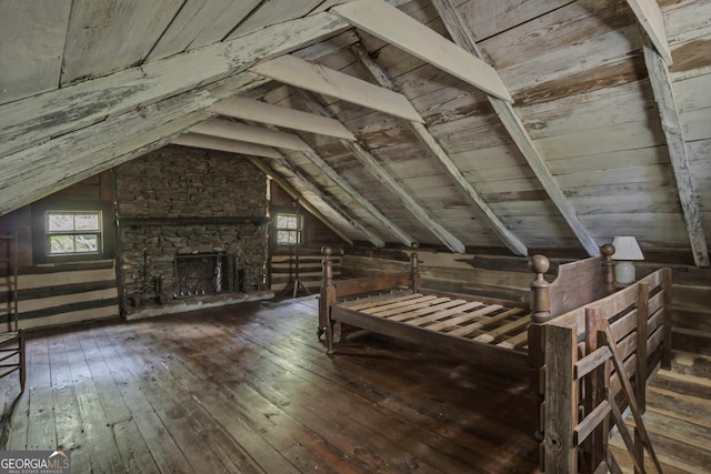 2724 Barnesville Hwy, Thomaston, GA 30286 - unfurnished bedroom with lofted ceiling, hardwood / wood-style floors, wooden ceiling, and a stone fireplace
