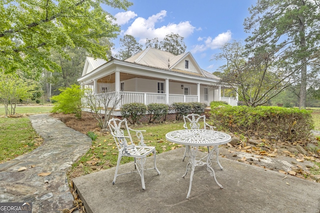 exterior space featuring covered porch and metal roof