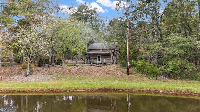 rear view of house featuring a water view