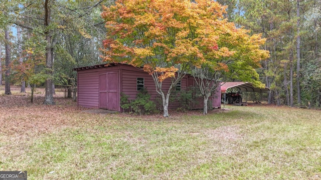 view of yard featuring a storage shed, a carport, and an outdoor structure