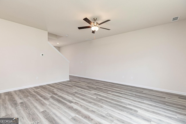 spare room with ceiling fan and light wood-type flooring