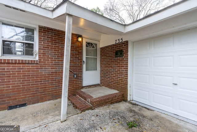 view of exterior entry with a garage