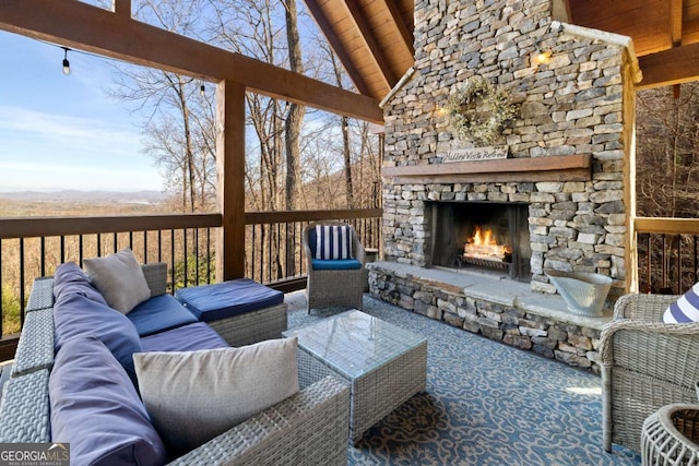 exterior space with vaulted ceiling with beams, wooden ceiling, and an outdoor stone fireplace