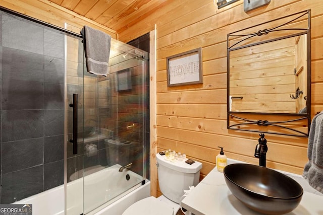 full bathroom with wooden walls, enclosed tub / shower combo, vanity, toilet, and wooden ceiling