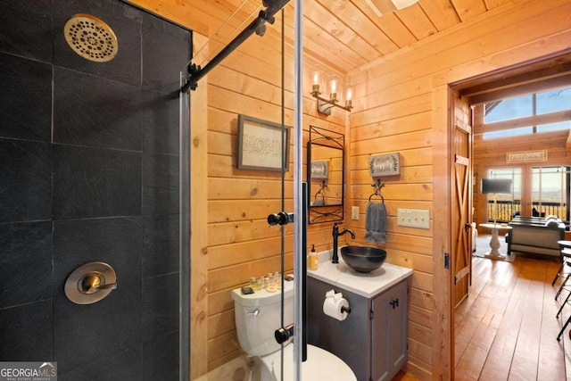 bathroom featuring wood walls, wood-type flooring, vanity, wood ceiling, and toilet