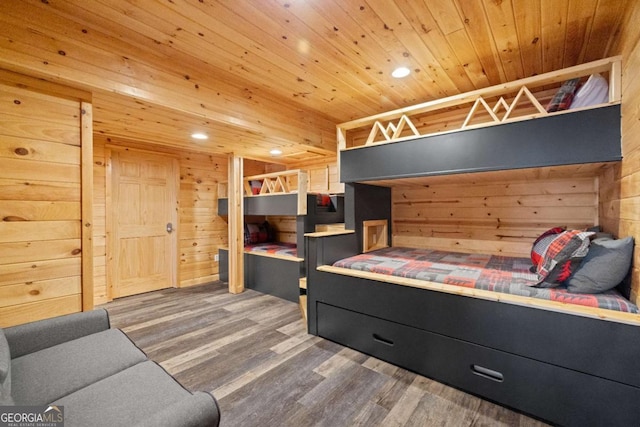 bedroom with wood ceiling, wooden walls, and dark hardwood / wood-style flooring