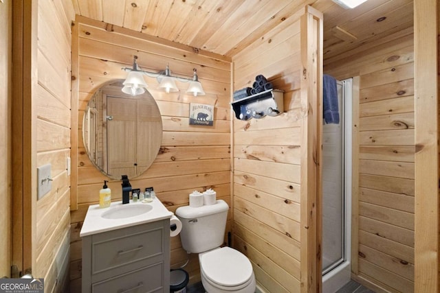 bathroom featuring toilet, a shower with shower door, wood ceiling, vanity, and wooden walls