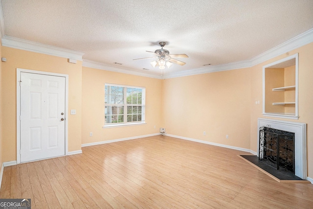 unfurnished living room with crown molding, a textured ceiling, and light wood-type flooring