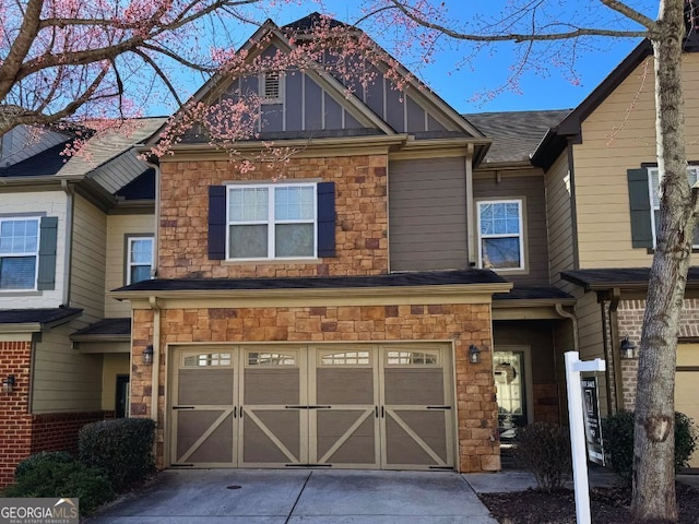 townhome / multi-family property featuring board and batten siding, concrete driveway, an attached garage, and stone siding