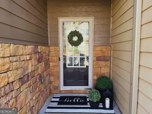 doorway to property with stone siding