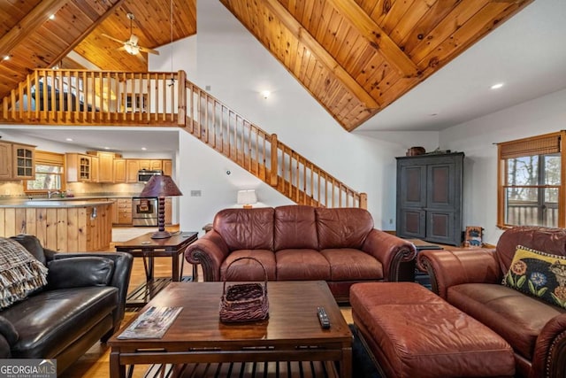 380 Oak Ridge Way, Morganton, GA 30560 - living area featuring high vaulted ceiling, stairs, wooden ceiling, a ceiling fan, and beam ceiling