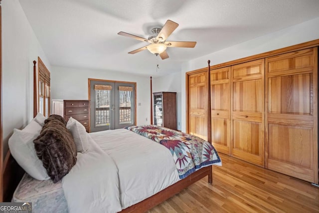 bedroom featuring light hardwood / wood-style flooring, ceiling fan, access to exterior, a textured ceiling, and french doors