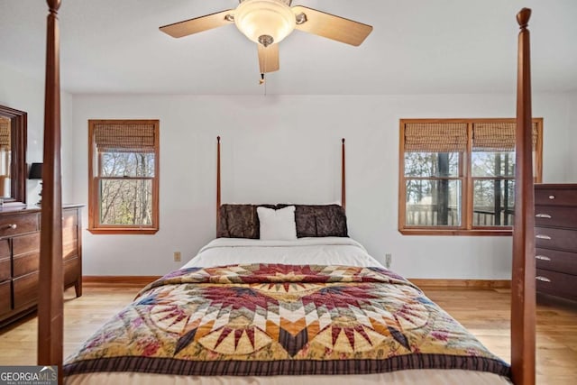 bedroom with light hardwood / wood-style flooring and ceiling fan