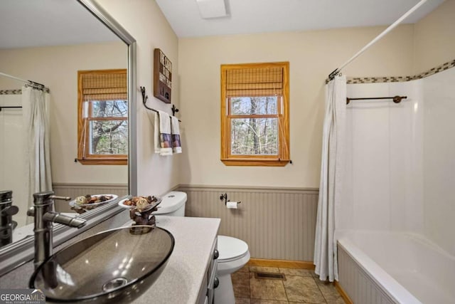 full bathroom with vanity, toilet, and shower / bath combo