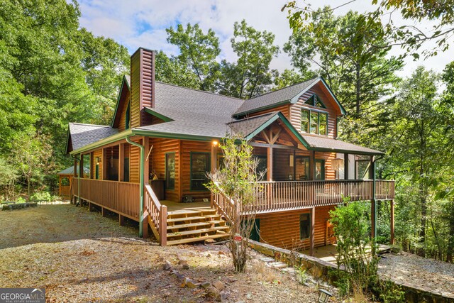 view of side of property featuring a wooden deck