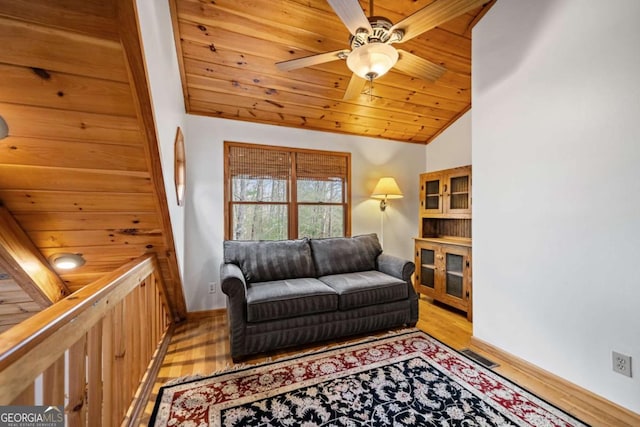 living room with vaulted ceiling, light wood-type flooring, ceiling fan, and wood ceiling