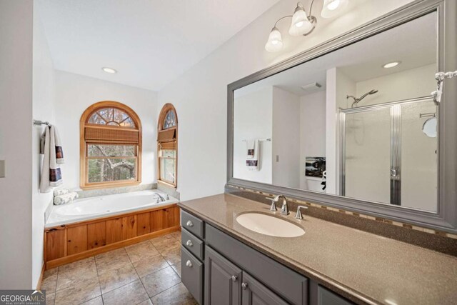 full bathroom with toilet, tile patterned floors, vanity, and plus walk in shower