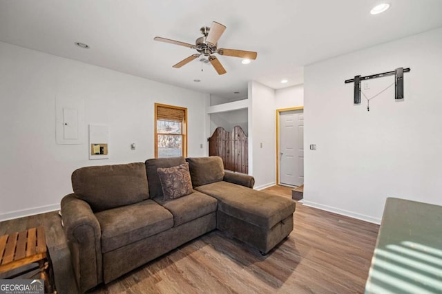 living room with hardwood / wood-style flooring and ceiling fan