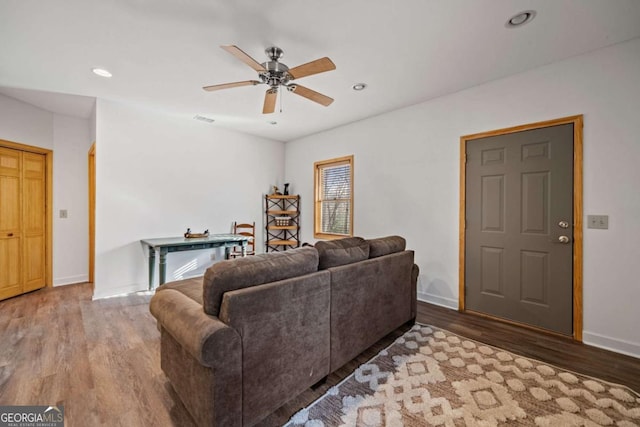 living room with hardwood / wood-style floors and ceiling fan