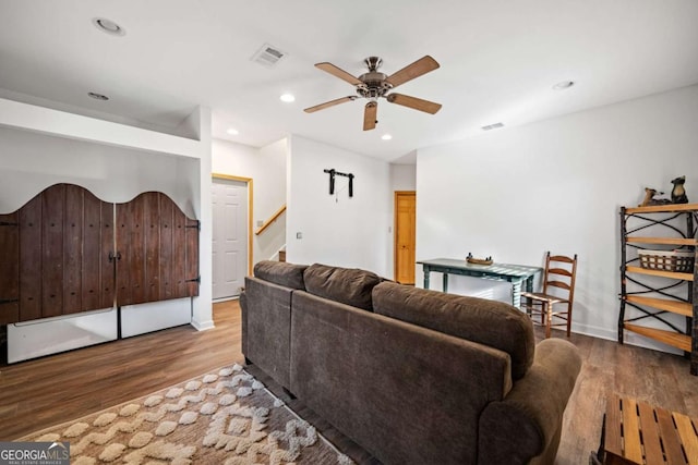 living room featuring ceiling fan and light hardwood / wood-style flooring