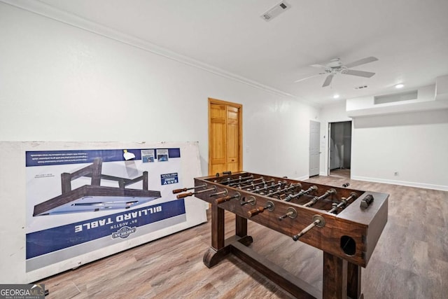 game room featuring ornamental molding, hardwood / wood-style floors, and ceiling fan