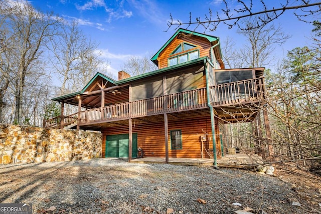 view of front of house featuring a wooden deck and a sunroom