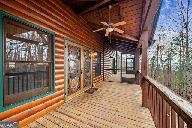 view of front of house featuring a wooden deck and an outdoor fire pit