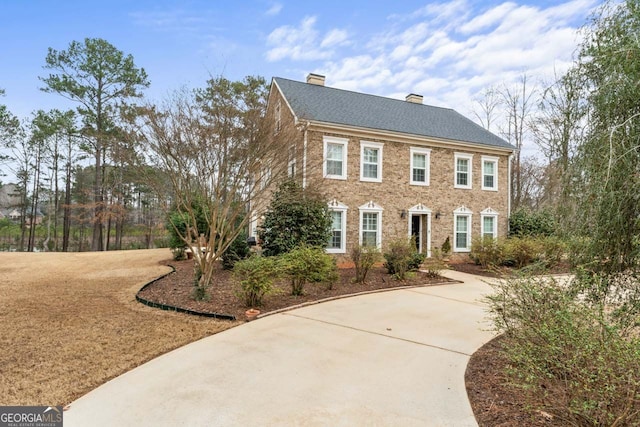 256 Allie Dr, Mcdonough, GA 30252 - colonial-style house with driveway and a chimney