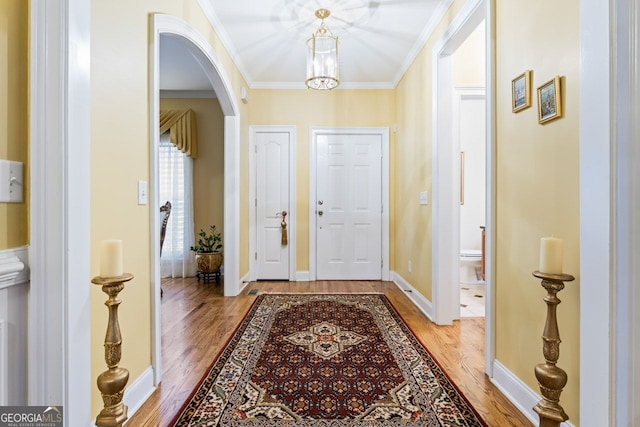 256 Allie Dr, Mcdonough, GA 30252 - entryway with baseboards, light wood-type flooring, crown molding, and arched walkways