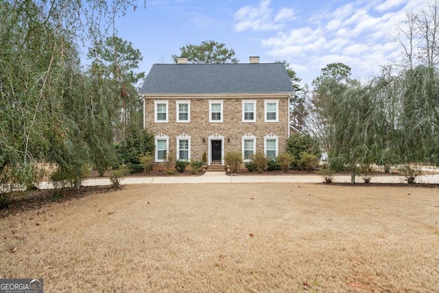 256 Allie Dr, Mcdonough, GA 30252 - colonial house featuring a chimney and brick siding