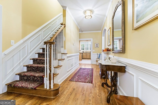 256 Allie Dr, Mcdonough, GA 30252 - foyer with stairs, light wood-style floors, crown molding, and wainscoting