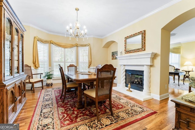 256 Allie Dr, Mcdonough, GA 30252 - dining room with arched walkways, crown molding, and light wood finished floors