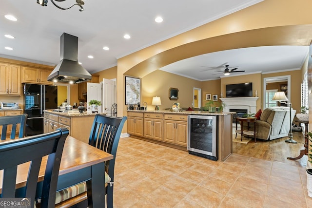 256 Allie Dr, Mcdonough, GA 30252 - kitchen featuring a peninsula, a center island with sink, beverage cooler, island exhaust hood, and ceiling fan