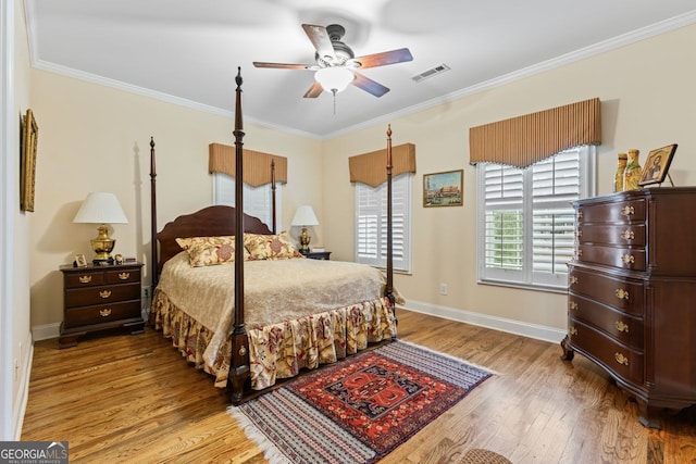256 Allie Dr, Mcdonough, GA 30252 - bedroom featuring crown molding, light wood-type flooring, baseboards, visible vents, and a ceiling fan
