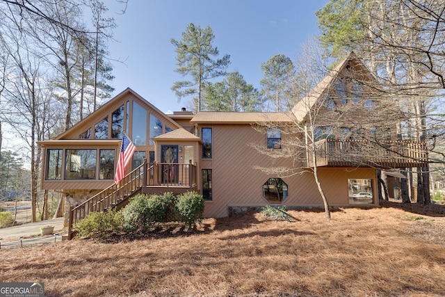 view of front of house with stairway and a deck