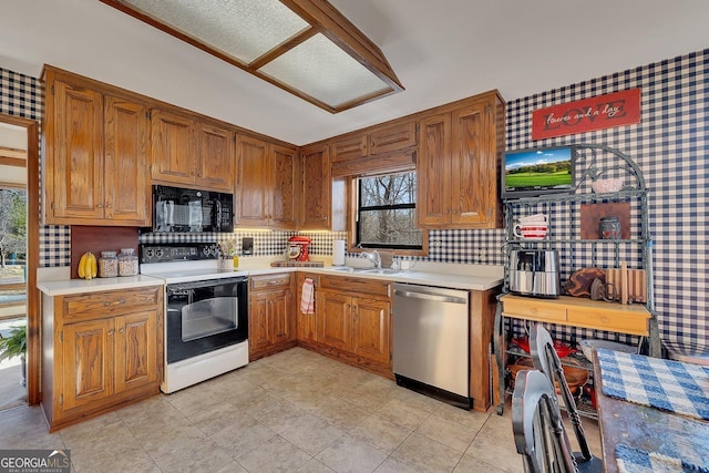 kitchen with black microwave, light countertops, dishwasher, and electric range oven