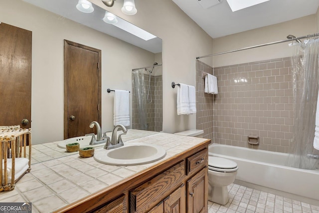 full bathroom featuring toilet, a skylight, shower / bath combo, and vanity