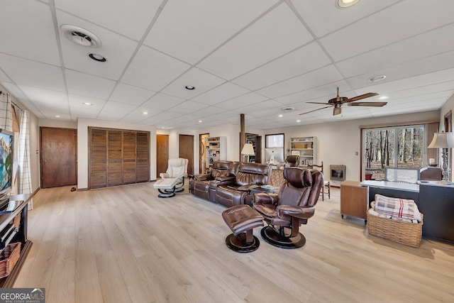 living room featuring visible vents, light wood-type flooring, a paneled ceiling, and recessed lighting