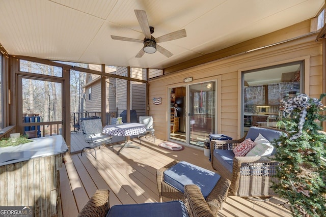 sunroom with a ceiling fan