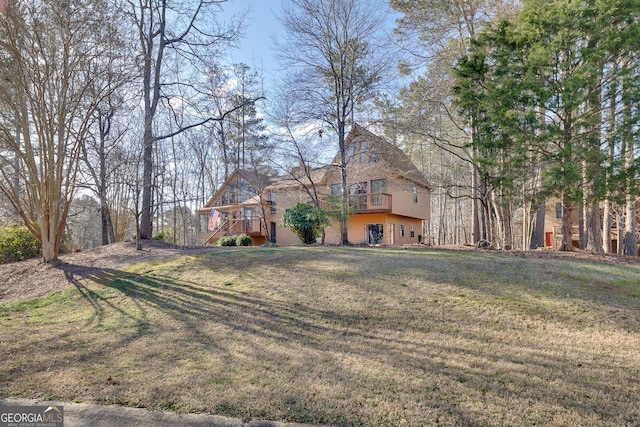 view of front of home featuring a deck and a front yard