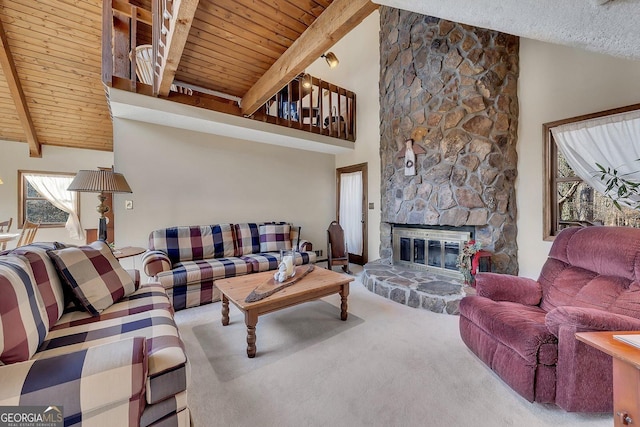 carpeted living area featuring wood ceiling, high vaulted ceiling, a fireplace, and beam ceiling