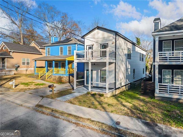 view of front of property with a porch, a residential view, and a balcony