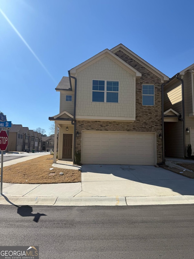 view of front of property with a garage, concrete driveway, and brick siding