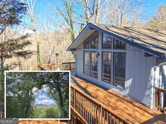 view of side of home with a shingled roof and a balcony