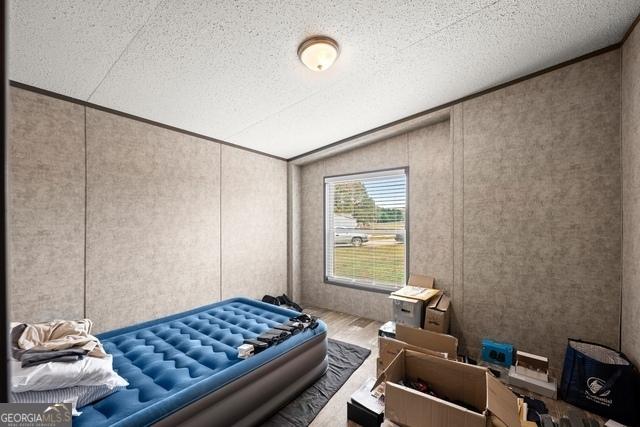 bedroom featuring lofted ceiling and wood finished floors